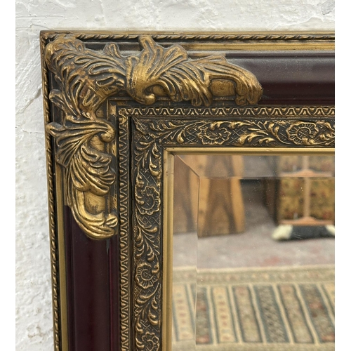 19 - A 19th century style red lacquered and gilt framed bevelled edge wall mirror - approx. 110cm x 79cm