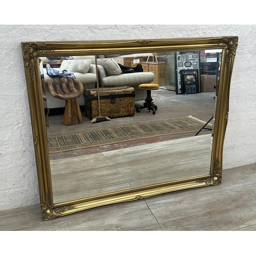 22 - A 19th century style gilt framed bevelled edge wall mirror - approx. 107cm high x 132cm wide