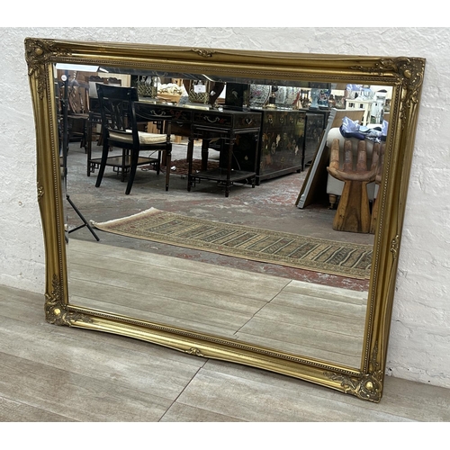 22 - A 19th century style gilt framed bevelled edge wall mirror - approx. 107cm high x 132cm wide