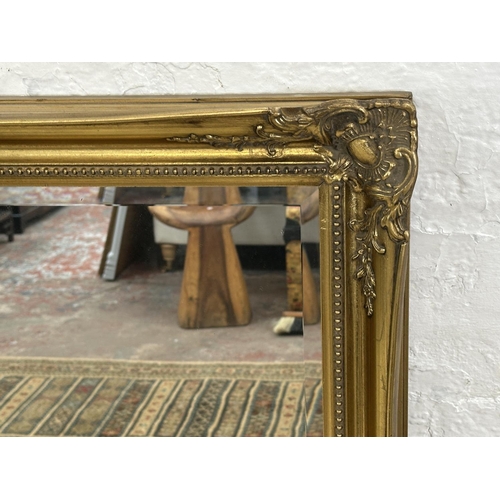 22 - A 19th century style gilt framed bevelled edge wall mirror - approx. 107cm high x 132cm wide