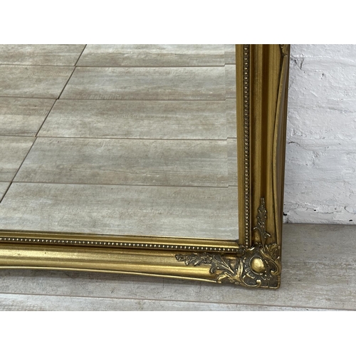 22 - A 19th century style gilt framed bevelled edge wall mirror - approx. 107cm high x 132cm wide