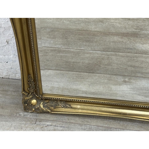 22 - A 19th century style gilt framed bevelled edge wall mirror - approx. 107cm high x 132cm wide