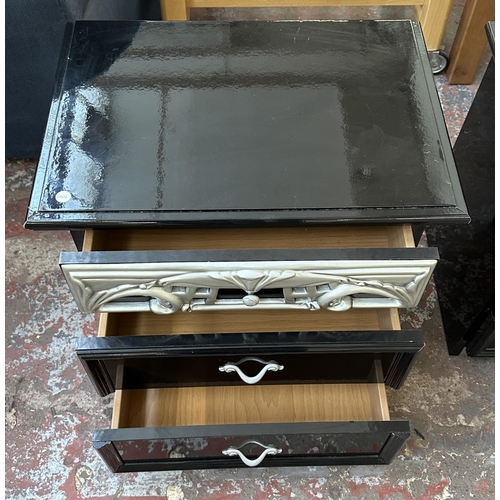 225 - A pair of modern black and silver lacquered bedside chests of drawers - approx. 55cm high x 58cm wid... 