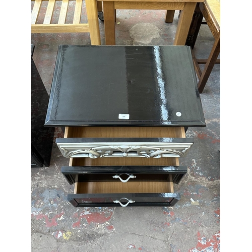 225 - A pair of modern black and silver lacquered bedside chests of drawers - approx. 55cm high x 58cm wid... 