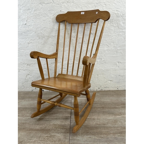 228 - A Victorian style beech spindle back farmhouse rocking chair