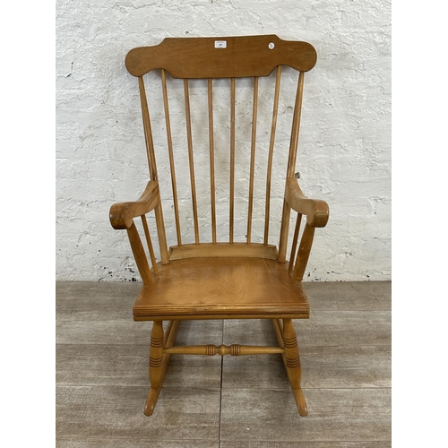 228 - A Victorian style beech spindle back farmhouse rocking chair