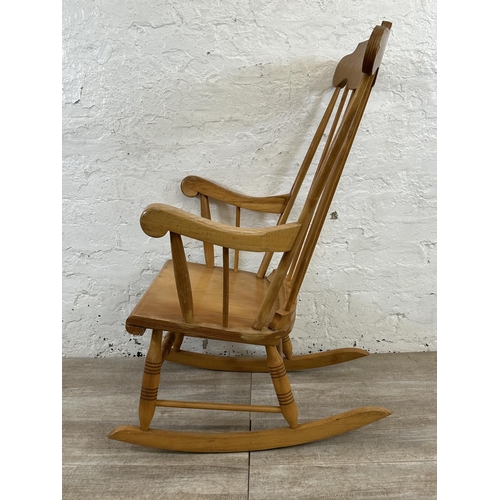 228 - A Victorian style beech spindle back farmhouse rocking chair