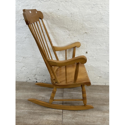 228 - A Victorian style beech spindle back farmhouse rocking chair