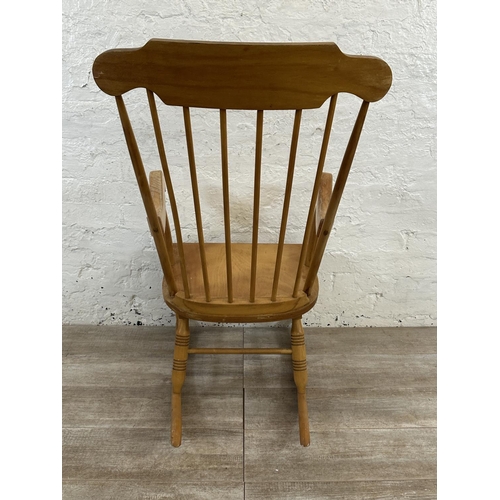 228 - A Victorian style beech spindle back farmhouse rocking chair