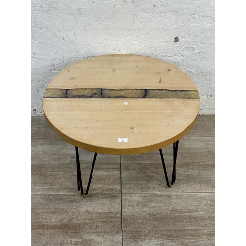 229 - A modern beech and epoxy resin circular coffee table on metal hairpin supports - approx. 44cm high x... 