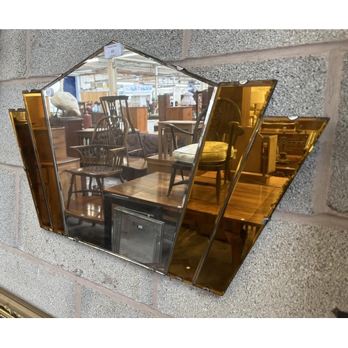 23 - An Art Deco amber glass frameless bevelled edge fan shaped wall mirror - approx. 41cm high x 69cm wi... 