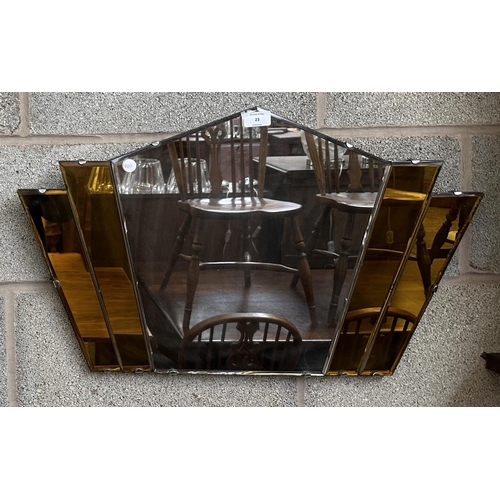 23 - An Art Deco amber glass frameless bevelled edge fan shaped wall mirror - approx. 41cm high x 69cm wi... 