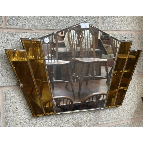 23 - An Art Deco amber glass frameless bevelled edge fan shaped wall mirror - approx. 41cm high x 69cm wi... 