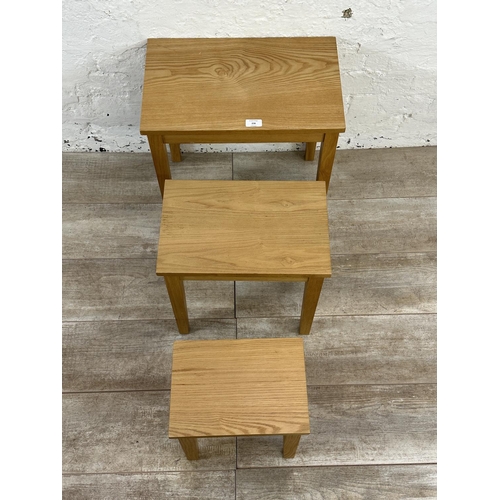 236 - A modern oak nest of three tables - approx. 45cm high x 48cm wide x 30cm deep