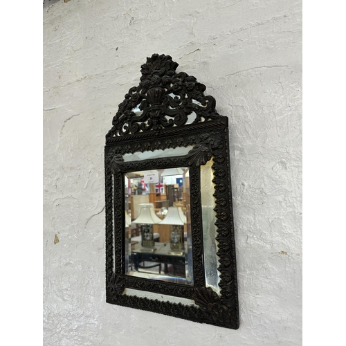 25 - A Napoleon III embossed copper framed cushion wall mirror - approx. 58cm high x 32cm wide