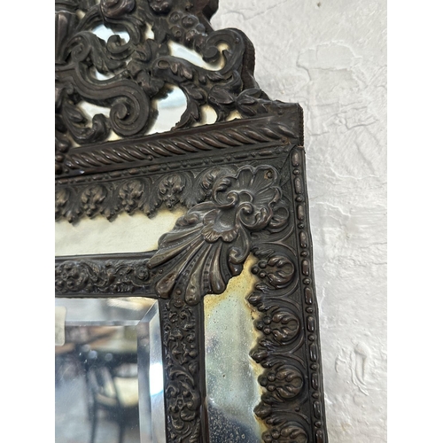 25 - A Napoleon III embossed copper framed cushion wall mirror - approx. 58cm high x 32cm wide