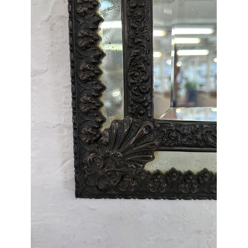 25 - A Napoleon III embossed copper framed cushion wall mirror - approx. 58cm high x 32cm wide