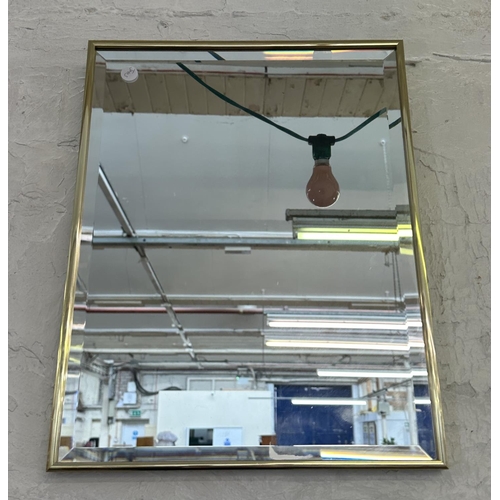 26 - A mid 20th century brass framed bevelled edge wall mirror - approx. 46cmn high x 36cm wide