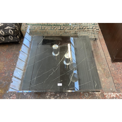 299 - A modern bevelled glass top and marble effect coffee table - approx. 36cm high x 95cm square