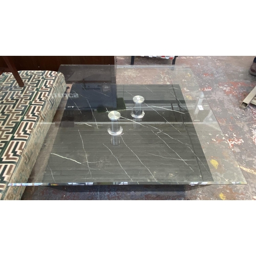 299 - A modern bevelled glass top and marble effect coffee table - approx. 36cm high x 95cm square