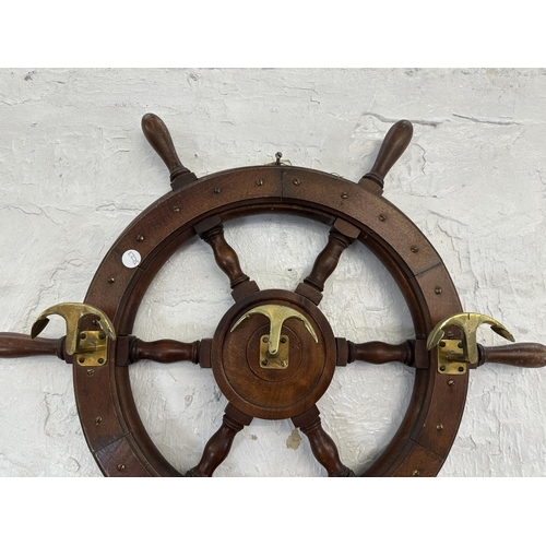 30 - A carved hardwood and brass novelty ships wheel coat rack - approx. 55cm diameter