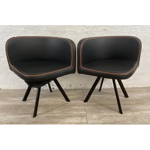 300 - A pair of modern black and orange faux leather space saving dining chairs