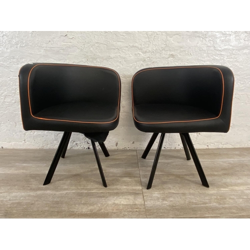 300 - A pair of modern black and orange faux leather space saving dining chairs