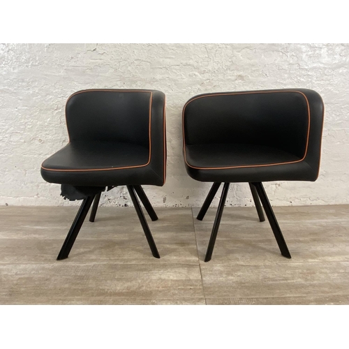 300 - A pair of modern black and orange faux leather space saving dining chairs