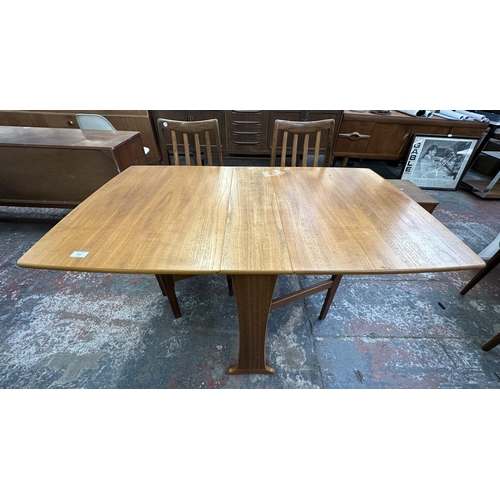 314 - A Legate teak drop leaf gate leg dining table and four G Plan Fresco teak and green fabric dining ch... 