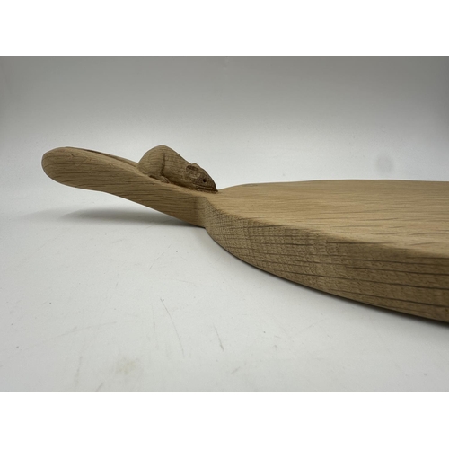 317 - A Robert 'Mouseman' Thompson adzed oak cheeseboard - approx. 39cm long