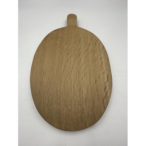 317 - A Robert 'Mouseman' Thompson adzed oak cheeseboard - approx. 39cm long