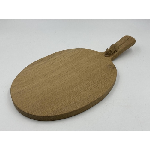 317 - A Robert 'Mouseman' Thompson adzed oak cheeseboard - approx. 39cm long