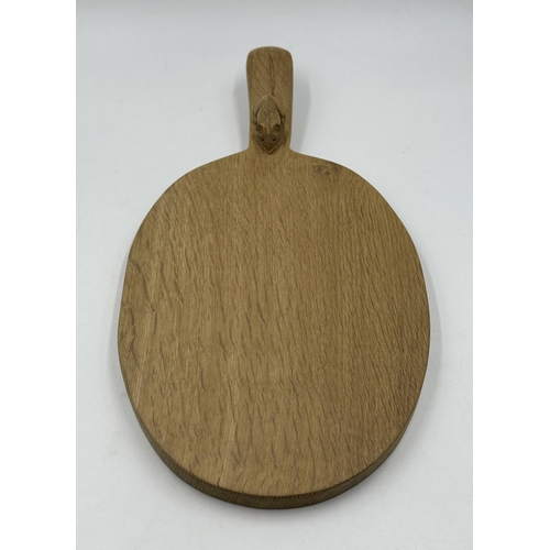 317 - A Robert 'Mouseman' Thompson adzed oak cheeseboard - approx. 39cm long