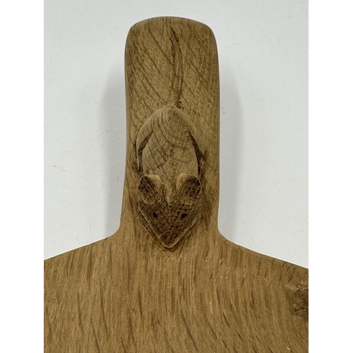 317 - A Robert 'Mouseman' Thompson adzed oak cheeseboard - approx. 39cm long