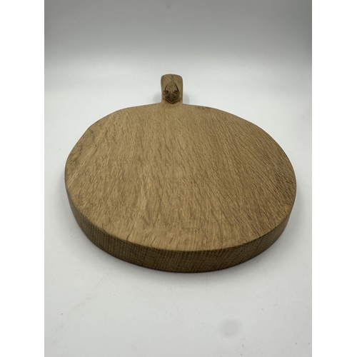 317 - A Robert 'Mouseman' Thompson adzed oak cheeseboard - approx. 39cm long