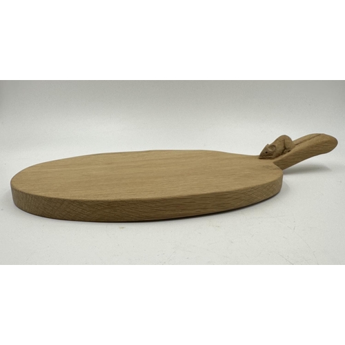 317 - A Robert 'Mouseman' Thompson adzed oak cheeseboard - approx. 39cm long