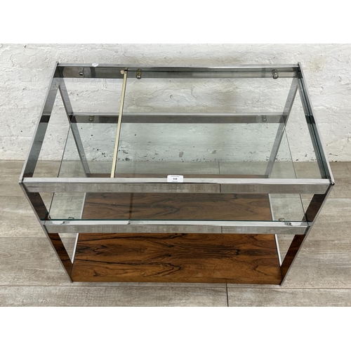 318 - A 1970s Merrow Associates rosewood and chrome plated drinks trolley with glass top, CITES A10 certif... 