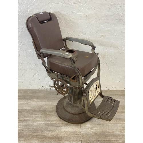 347 - An early 20th century cast iron and brown vinyl upholstered barber's chair - approx. 103cm high x 50... 