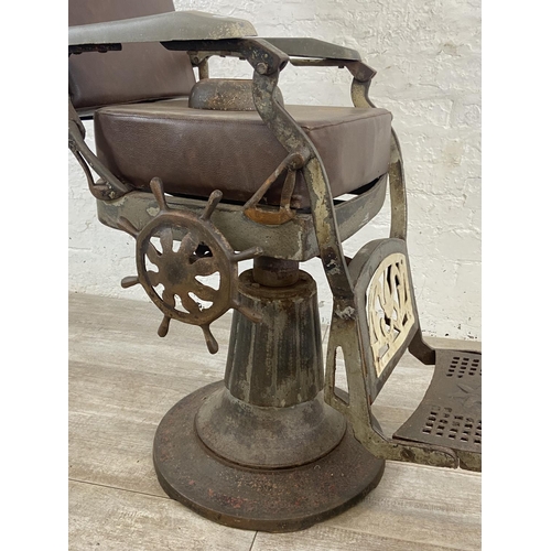 347 - An early 20th century cast iron and brown vinyl upholstered barber's chair - approx. 103cm high x 50... 