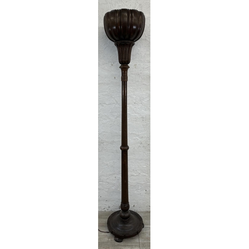 39 - A mid 20th century carved oak tulip shaped uplighter floor lamp - approx. 176cm high