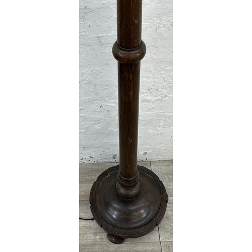 39 - A mid 20th century carved oak tulip shaped uplighter floor lamp - approx. 176cm high