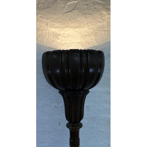 39 - A mid 20th century carved oak tulip shaped uplighter floor lamp - approx. 176cm high