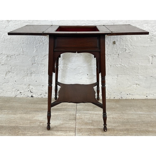 4 - An Edwardian mahogany fold over work table - approx. 66cm high x 76cm wide when extended x 38cm deep