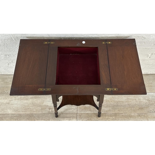 4 - An Edwardian mahogany fold over work table - approx. 66cm high x 76cm wide when extended x 38cm deep