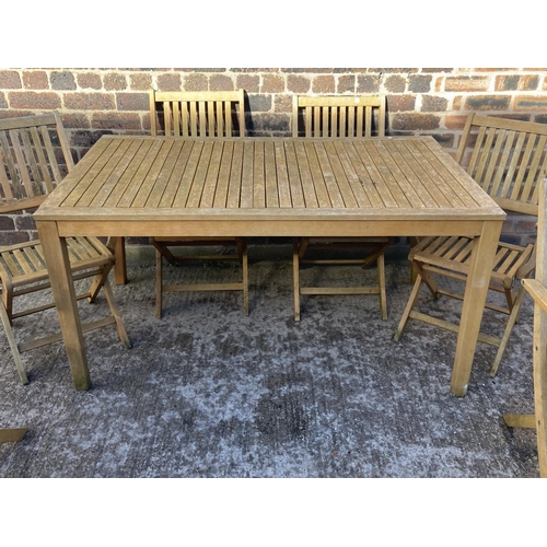 409 - A teak slatted seven piece patio set comprising rectangular table and six folding chairs - approx. 7... 