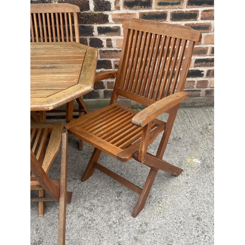 411 - A teak seven piece patio set comprising table and six folding chairs - approx. 73cm high x 78cm wide... 