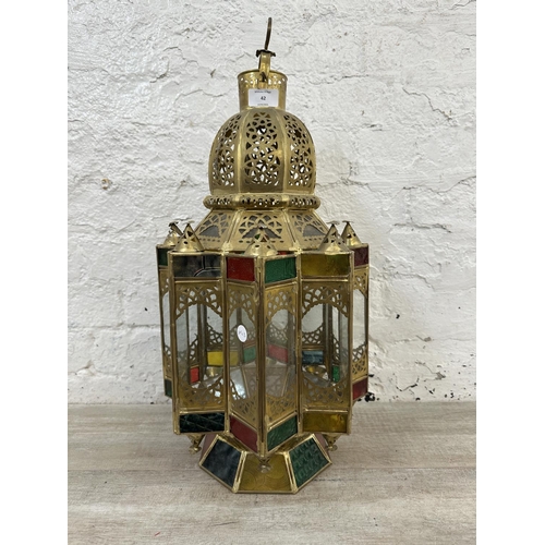 42 - A Moroccan gilt metal and stained glass hanging lantern - approx. 57cm high