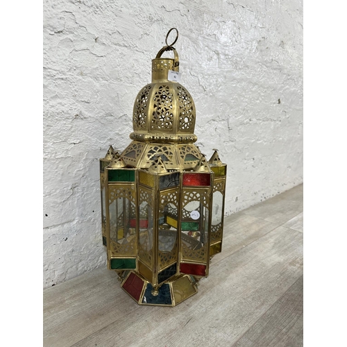 42 - A Moroccan gilt metal and stained glass hanging lantern - approx. 57cm high