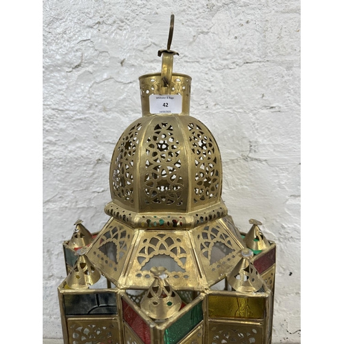 42 - A Moroccan gilt metal and stained glass hanging lantern - approx. 57cm high