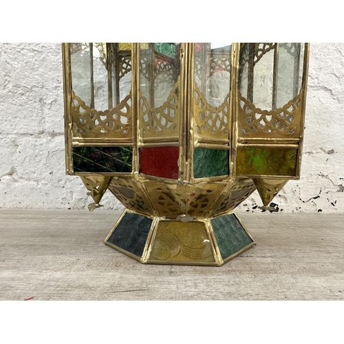 42 - A Moroccan gilt metal and stained glass hanging lantern - approx. 57cm high